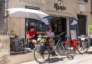 Cyclists eating an ice cream on a terrace