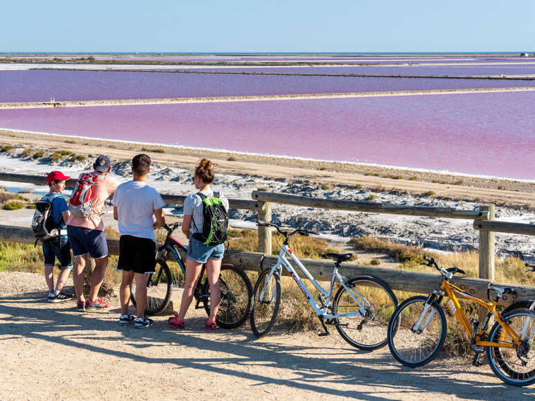 Cyclists in front of the salt marshes at Saintes-Maries-de-la-Mer
