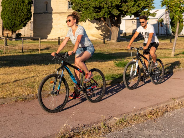 Cyclists passing in front of the Saint-Louis tower in Port-Saint-Louis-du-Rhône