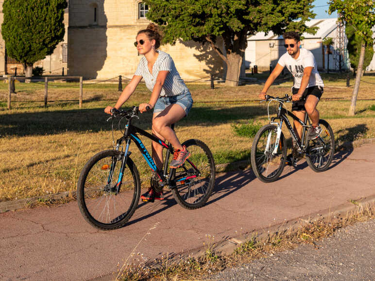 Cyclists passing in front of the Saint-Louis tower in Port-Saint-Louis-du-Rhône