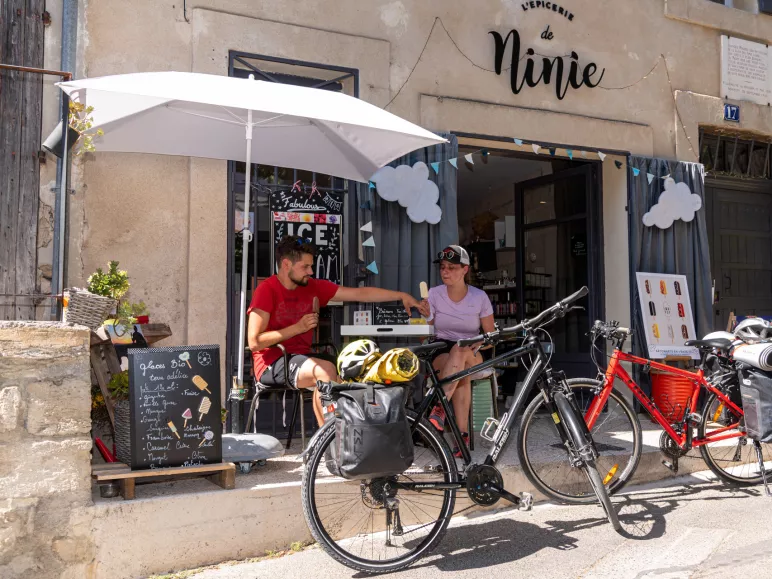 Cyclists eating an ice cream on a terrace